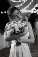 bride in a white dress throws a wedding bouquet photo