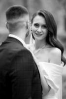 newlyweds walk in the park among cherry blossoms photo