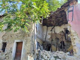 old abandoned roof collapsed farm house building in italy photo