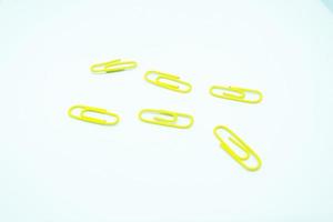 yellow paperclips in white background photo