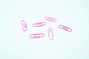 pink paperclips in white background photo