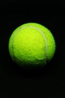 Darkened Delight, Tennis Ball Against a Black Background photo