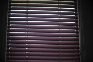 Blinds on window. Window in apartment. Closed blinds. photo