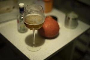 Glass with wine on table. Kitchen details. Items on kitchen table. photo