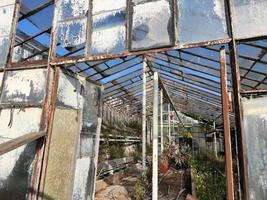 old abandoned greenhouse broken windows photo