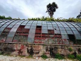 old abandoned greenhouse broken windows photo