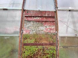 old abandoned greenhouse broken windows photo