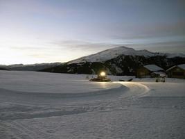 snowmobile on ski run at night photo