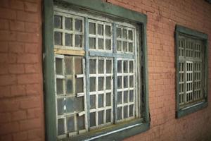 Old window in house. Details of 19th century architecture. Wooden lattice. Window frame. photo