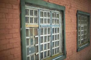 Old window in house. Details of 19th century architecture. Wooden lattice. Window frame. photo