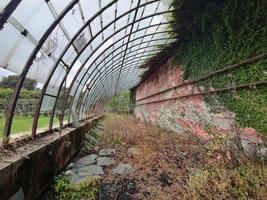 old abandoned greenhouse broken windows photo