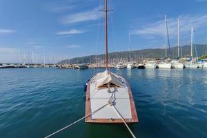 Wood sloop sail boat in harbor photo