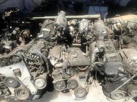 many old used car engine and parts photo