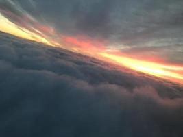 sunrise clouds in the sky from airplane window photo