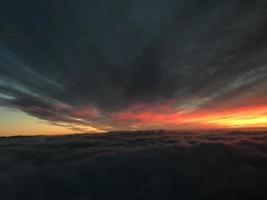 sunrise clouds in the sky from airplane window photo