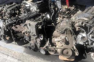 many old used car engine and parts photo