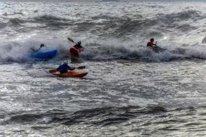 Kayaks in big waves in Genoa Nervi harbor photo
