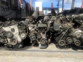 many old used car engine and parts photo