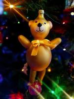 Circus Bear glass hand made christmas ball on xmas tree detail blur lights photo