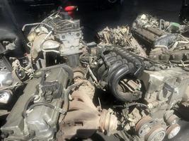 many old used car engine and parts photo