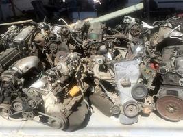 many old used car engine and parts photo