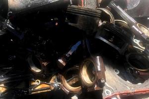 many old used car engine and parts photo