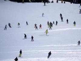 many skiers skiing in dolomites gardena valley snow mountains photo