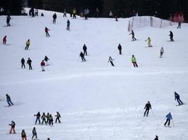 many skiers skiing in dolomites gardena valley snow mountains photo