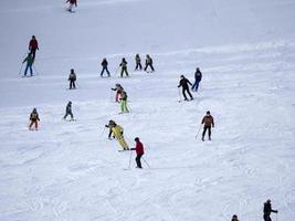 many skiers skiing in dolomites gardena valley snow mountains photo