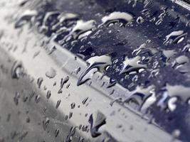 rain water drops on blue metallic surface photo