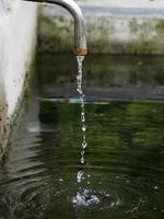 water drops from old fountain photo