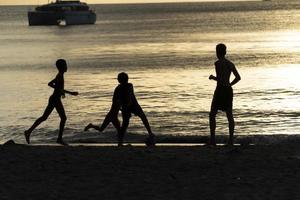 mahe, seychelles - 13 de agosto de 2019 - jóvenes criollos divirtiéndose en la playa foto