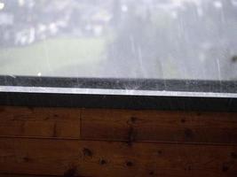 hailstorm on balcony in mountain hailstones while falling photo