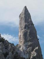 climber on Goloritze rock cliff by the sea Sardinia Italy photo