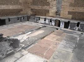 toilet old ancient ostia archeological ruins photo