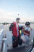 people after airplane window on rainy day photo