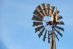 farm old windmill  for water on blue sky photo