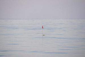 fishing net buoy in the middle of mediterranean sea photo