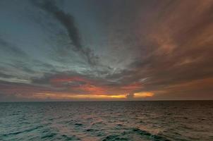 A colorful sunset in the middle of indian ocean in Maldives photo