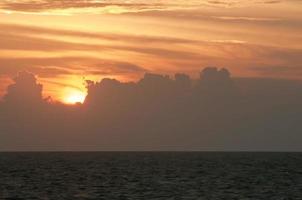 A colorful sunset in the middle of indian ocean in Maldives photo