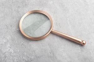 A magnifying glass on a gray background. For inserting images or text. photo