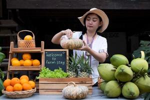 Native Asia woman selling natural variety of fruits at the farm stay, Homestay at Thailand Loei photo