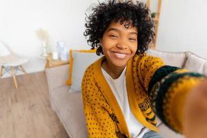 Happy african american teen blogger smiling face talking to webcam recording Social media influencer woman streaming making video call at home. Headshot portrait selfie webcamera view. 20202366 Photo