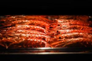 Grilled prawns on the grill and Grilled Shrimps. Shrimp barbecue on stainless tray in Electric oven for celebration night party at home. seafood photo