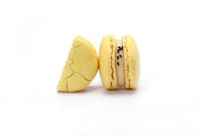 two cake of macaron or macaroon yellow lemon color. Delicious macaroon isolated on white background. French sweet cookie. photo