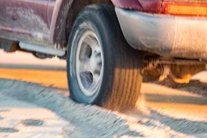 offroad car tire detail on sand beach photo