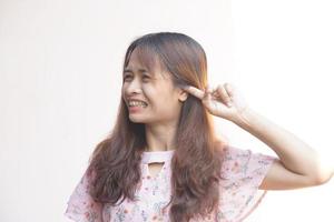 Asian woman having itchy ears photo