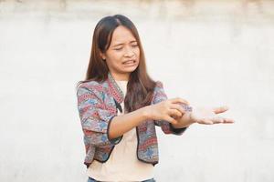 Asian woman having an itchy arm photo