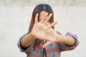 Asian women use their hands to prevent them from entering. photo