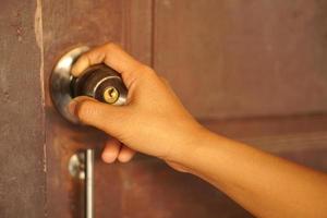 Female hand opening the door photo